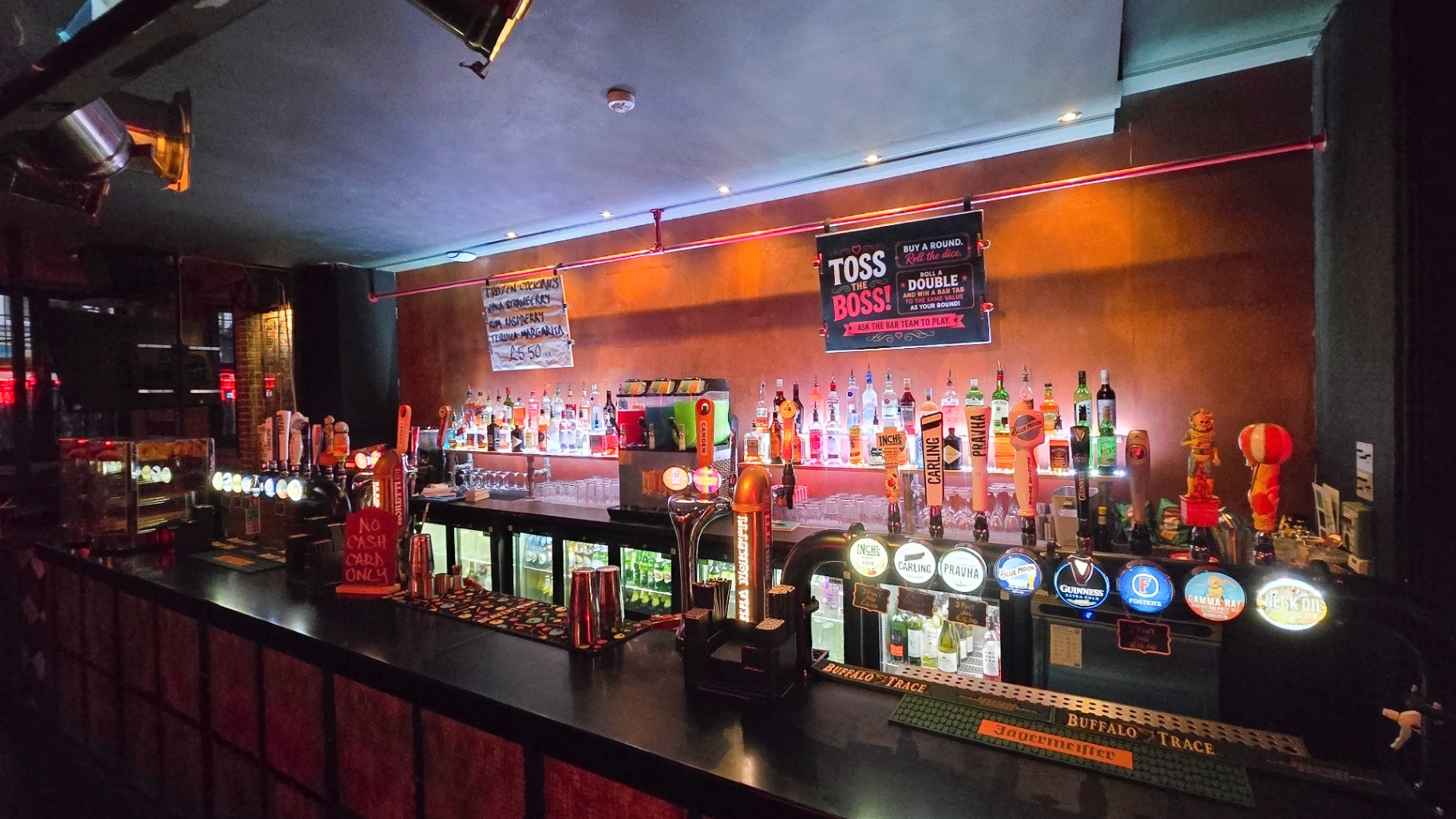 The Hot Toddy's bar with Toss the Boss sign and taps
