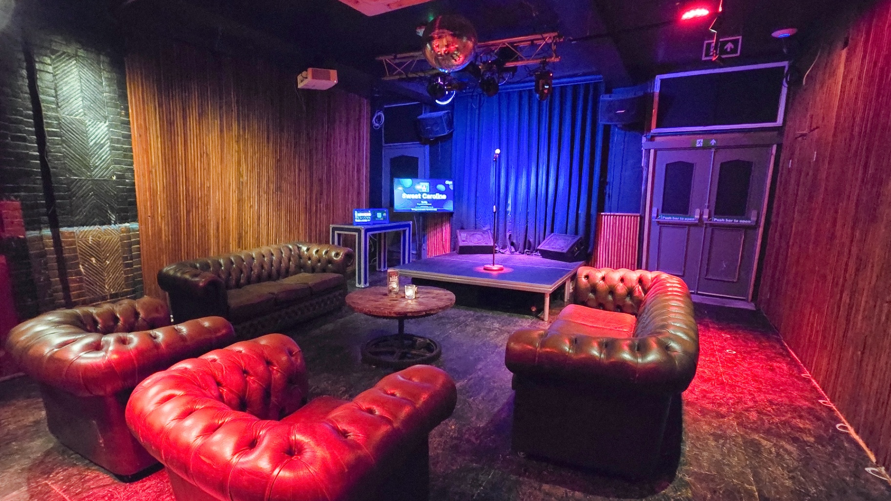 Full private karaoke room view from the back