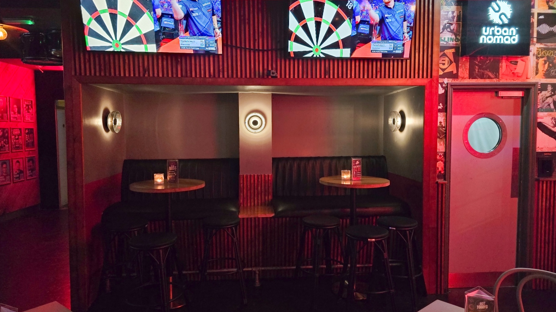 Green leather booth under the darts screens