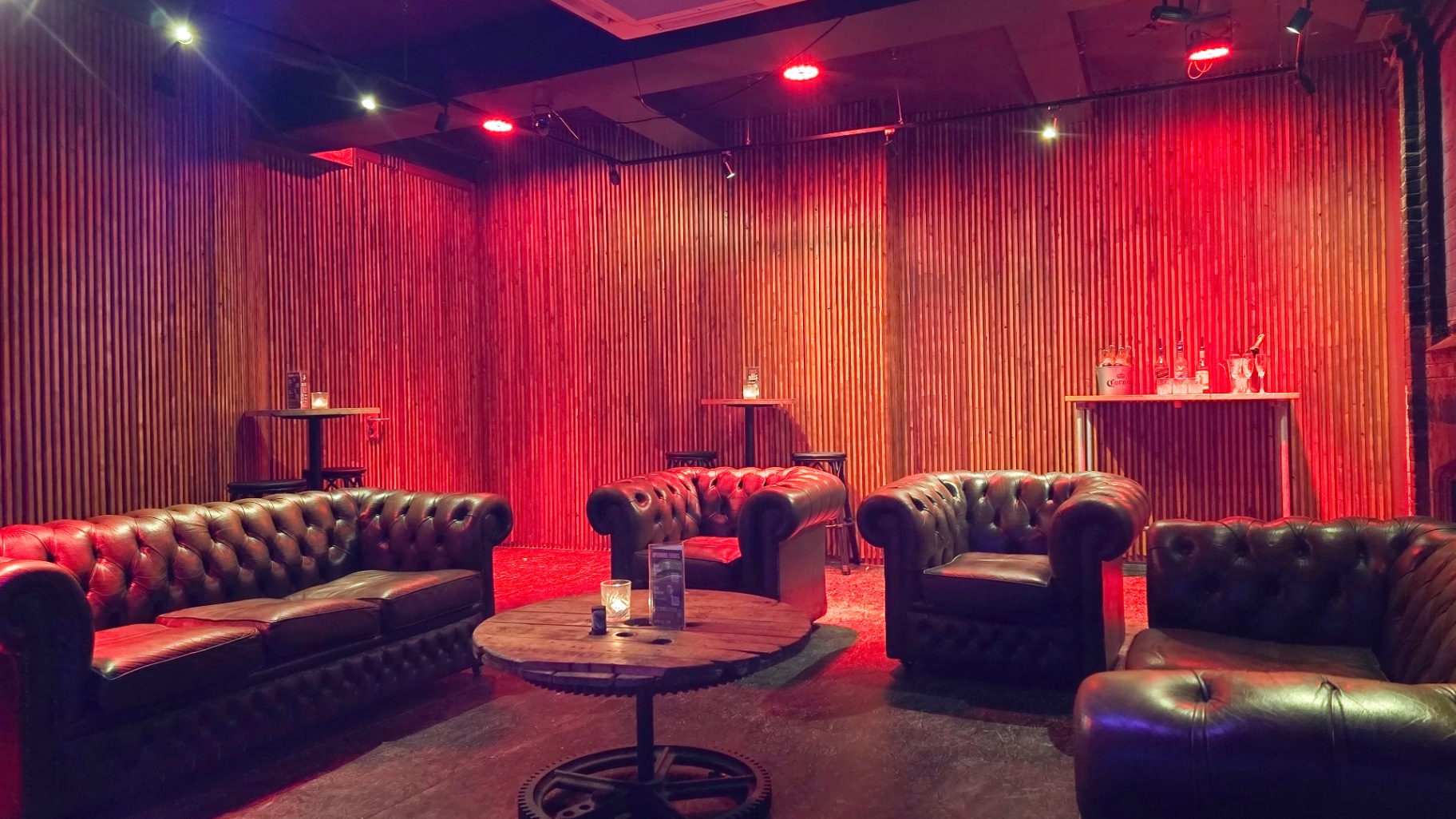 Back lounge with tables, stools and bottle service