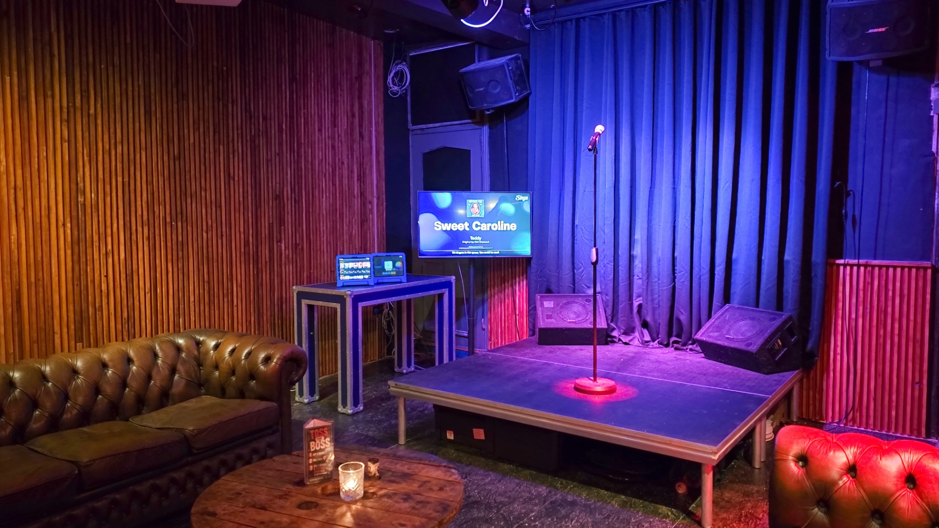 Stage with mic, screen and Chesterfield seating
